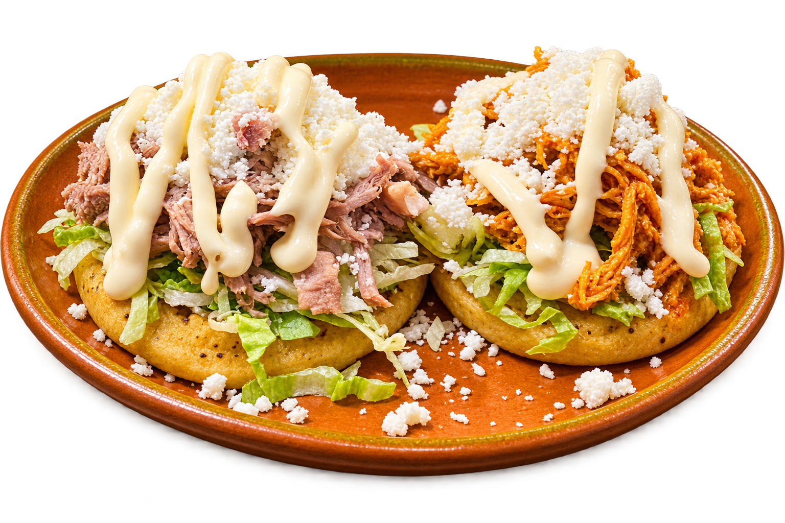 Sopes topped with lettuce, cheese and crema